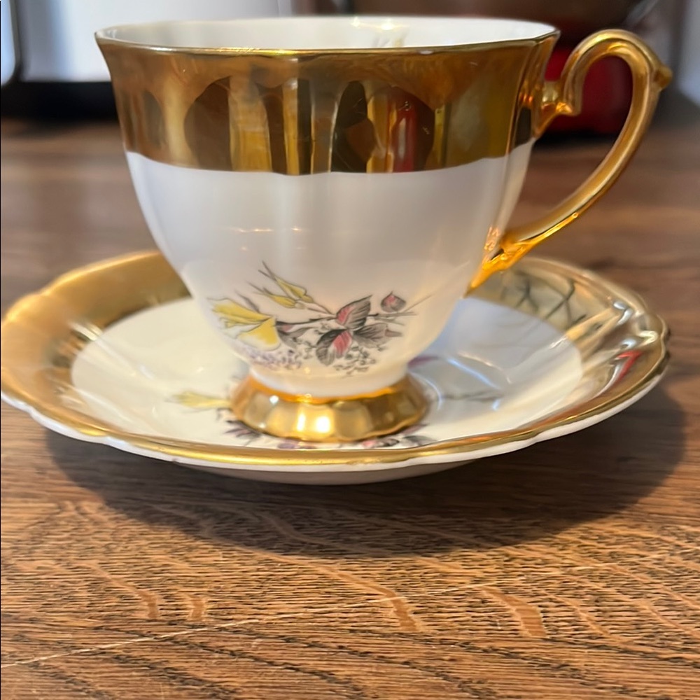 Elegant Gold and White Teacup with Saucer